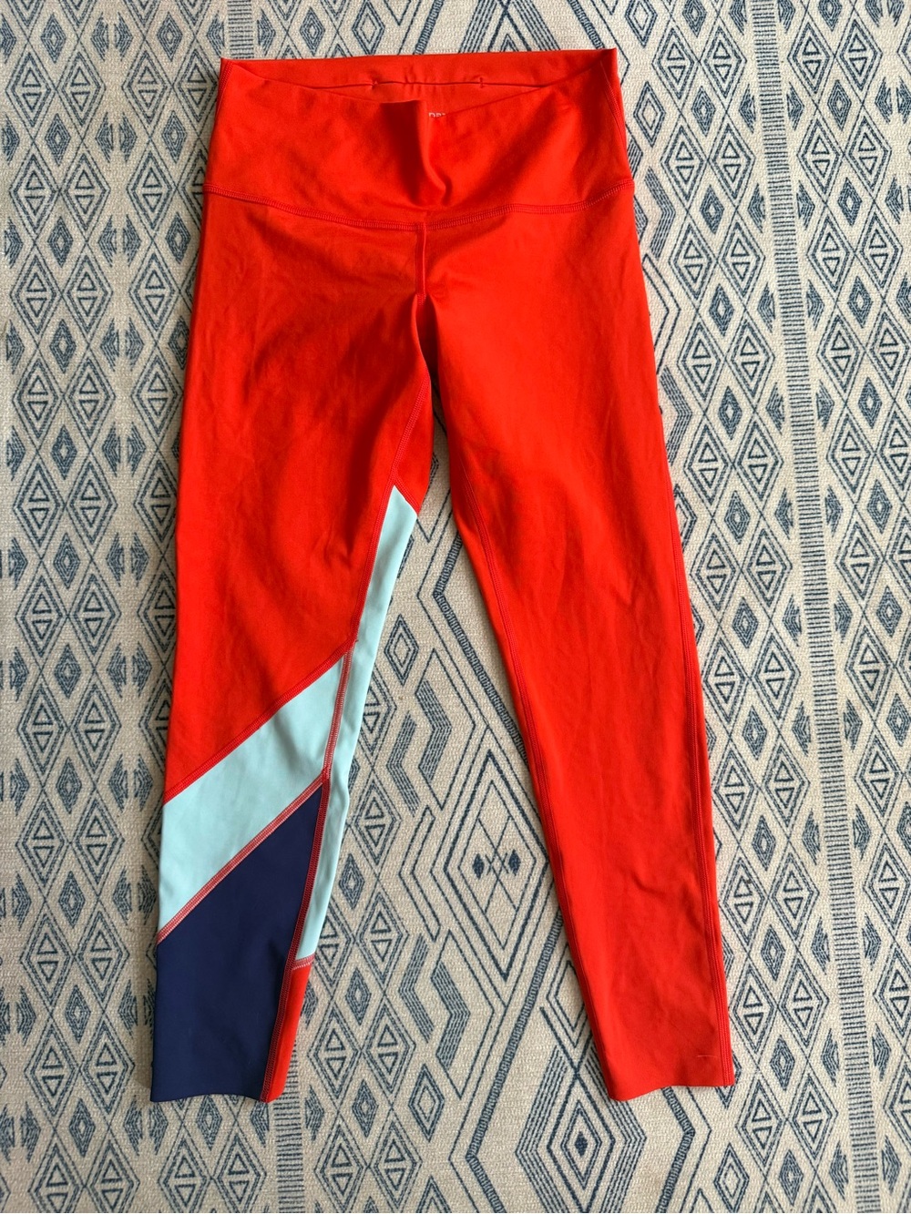 cotopaxi Bright Red Leggings with Light Blue and Navy Panels